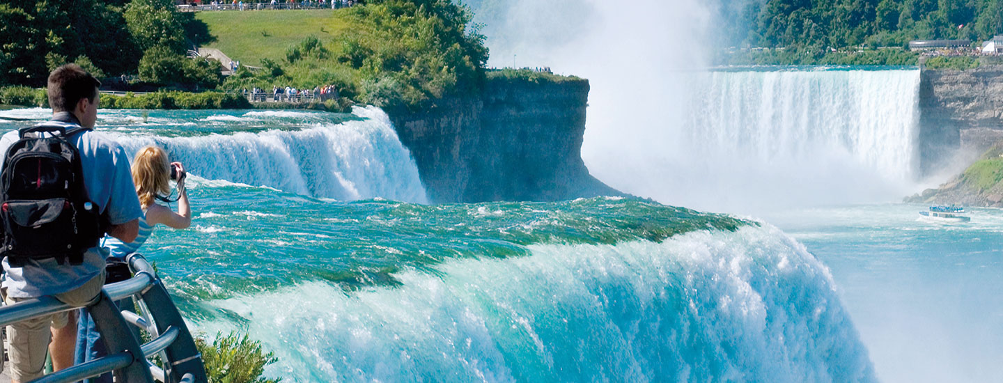 Tourists admire the giant waterfalls of Niagara Falls.