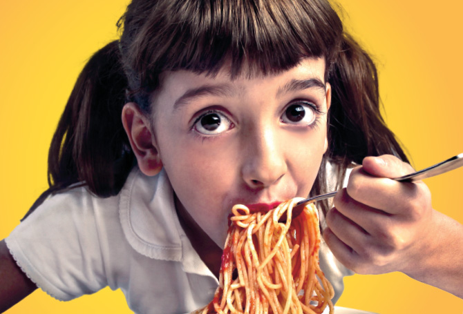 Enlargeable photo of a child eating spaghetti