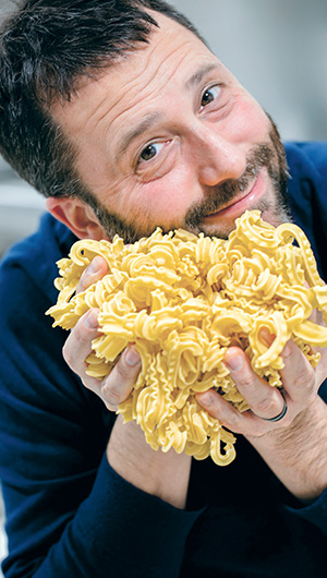 Photo of a man holding noodles